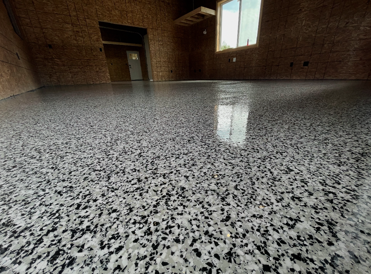 Black and white flake epoxy garage floor coating by HKH Custom Coatings
