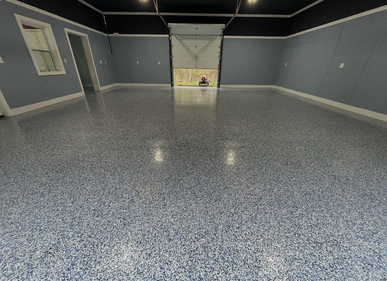 Blue flake epoxy garage floor coating in a finished garage