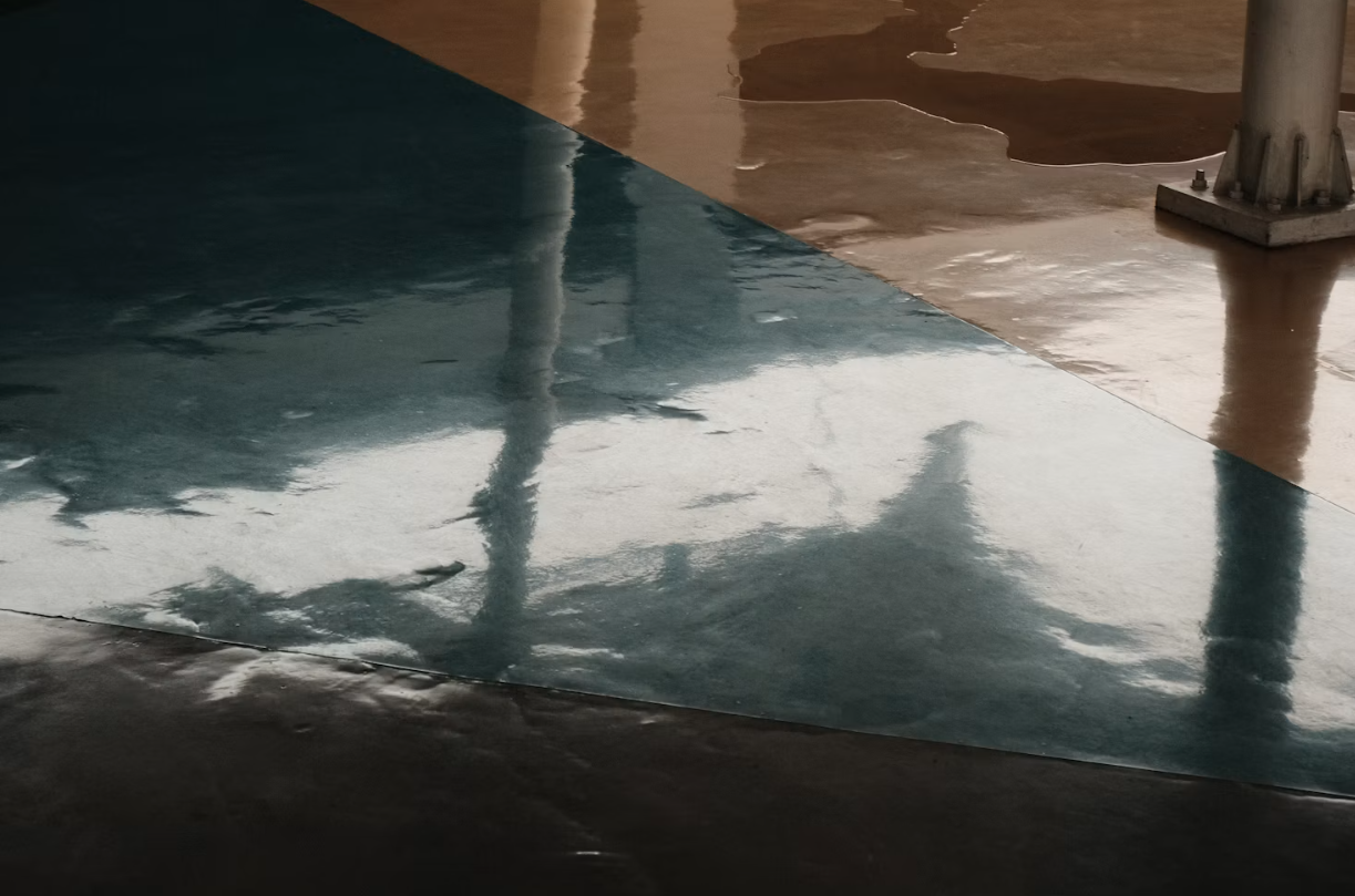 Epoxy coating being poured and spread during a floor installation