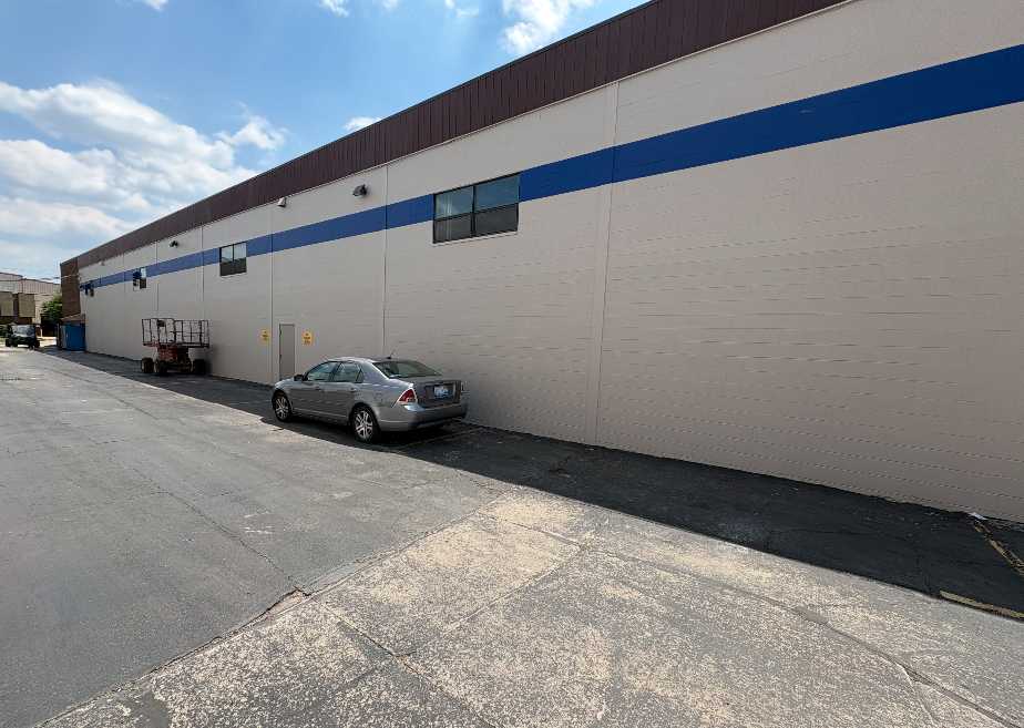 Commercial exterior painting project with a painted accent stripe