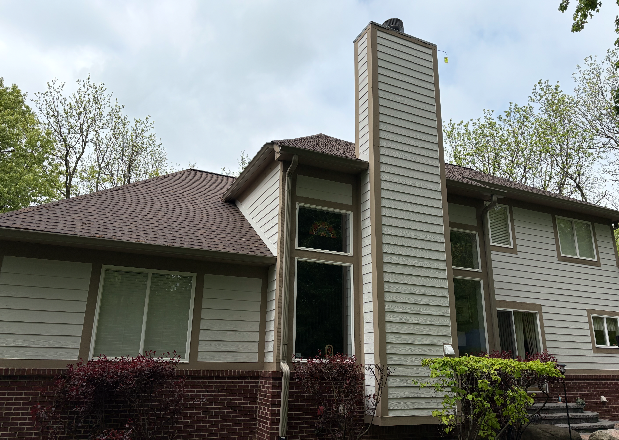 Exterior siding painting in progress on a Rochester Hills area home